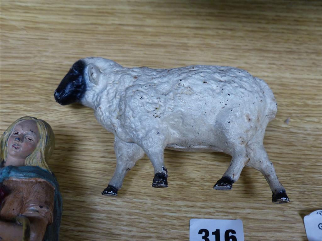 A group of American? painted cast iron and metal Amish figures, sheep money box etc.